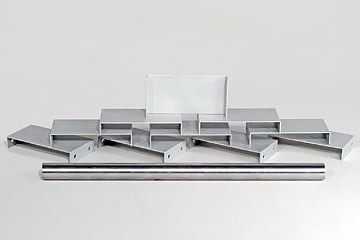 Assorted metal brackets and a long rod arranged on a white background.