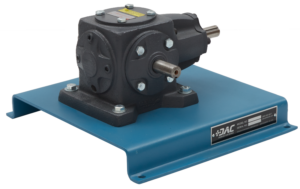 Industrial gear reducer mounted on a blue metal base with a protruding shaft on the right and bolted flanges edge-to-edge, label visible on base