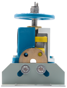 Small blue manual press with a large hand wheel on top and yellow gears inside the housing