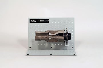 Bench-mounted metal fixture attached to a gray perforated back panel on a base.