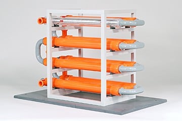 Industrial pipe rack with orange tubes and gray fittings mounted on a white frame on a metal base (lab/test rig)