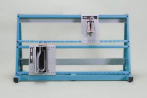 Blue metal frame with two mounted electrical panels and exposed wiring.