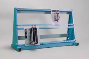 Blue metal tool storage rack with two mounted organizer panels holding handheld tools in a studio backdrop.
