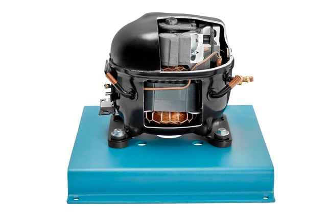 Hermetic refrigerator/AC compressor mounted on a blue metal base with copper tubing and electrical connections (informative image).