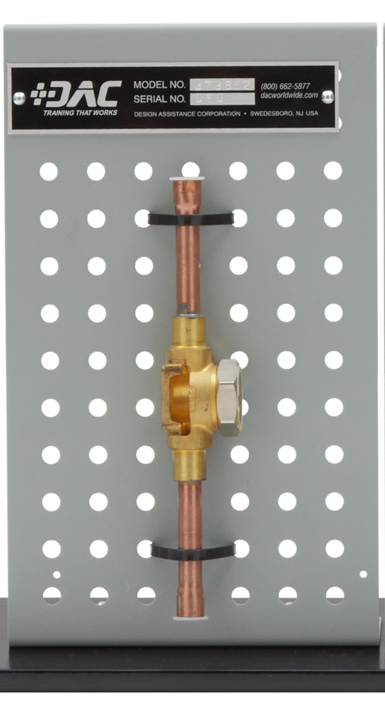Copper water line with brass valve mounted on a gray perforated board; label reads DAC Training That Works, showing a vertical copper tube secured with black clamps.
