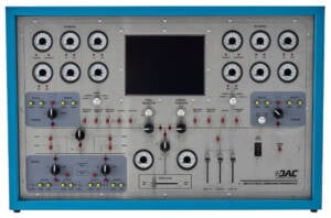 Industrial electrical control panel mounted in a blue metal frame with numerous gauges, switches, and a central display screen used to monitor and control generator outputs and turbine settings.