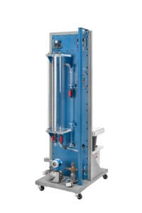 Vertical industrial test rig on a wheeled base with blue control panel, tubing, gauges, and valves.