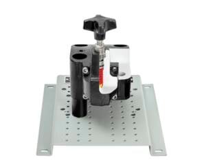 Bench-top toggle clamp mounted to a perforated metal base used to hold a workpiece in place.