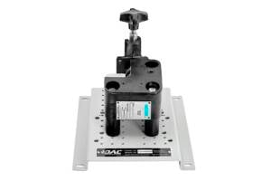 Adjustable clamping fixture with a handwheel mounted on a perforated base plate used for precise part positioning.