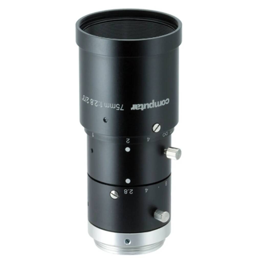 Black cylindrical camera extension tube with adjustment dials and measurement markings, viewed from the side.