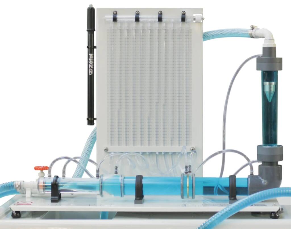 Lab apparatus with clear blue liquid flowing through tubing into a white control unit and a right-side pump assembly.