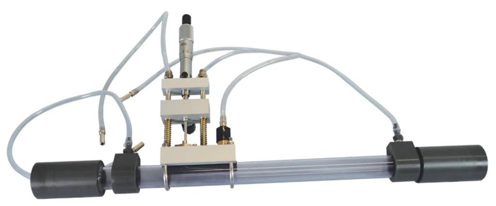 Industrial pneumatic linear actuator with tubing, mounting blocks, and piston assembly on a gray guide rod