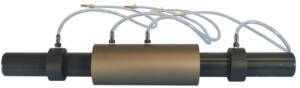 Inline clamp-on sensor with tubing attached to a black pipe, featuring a large central brown protective sleeve and two pipe clamps