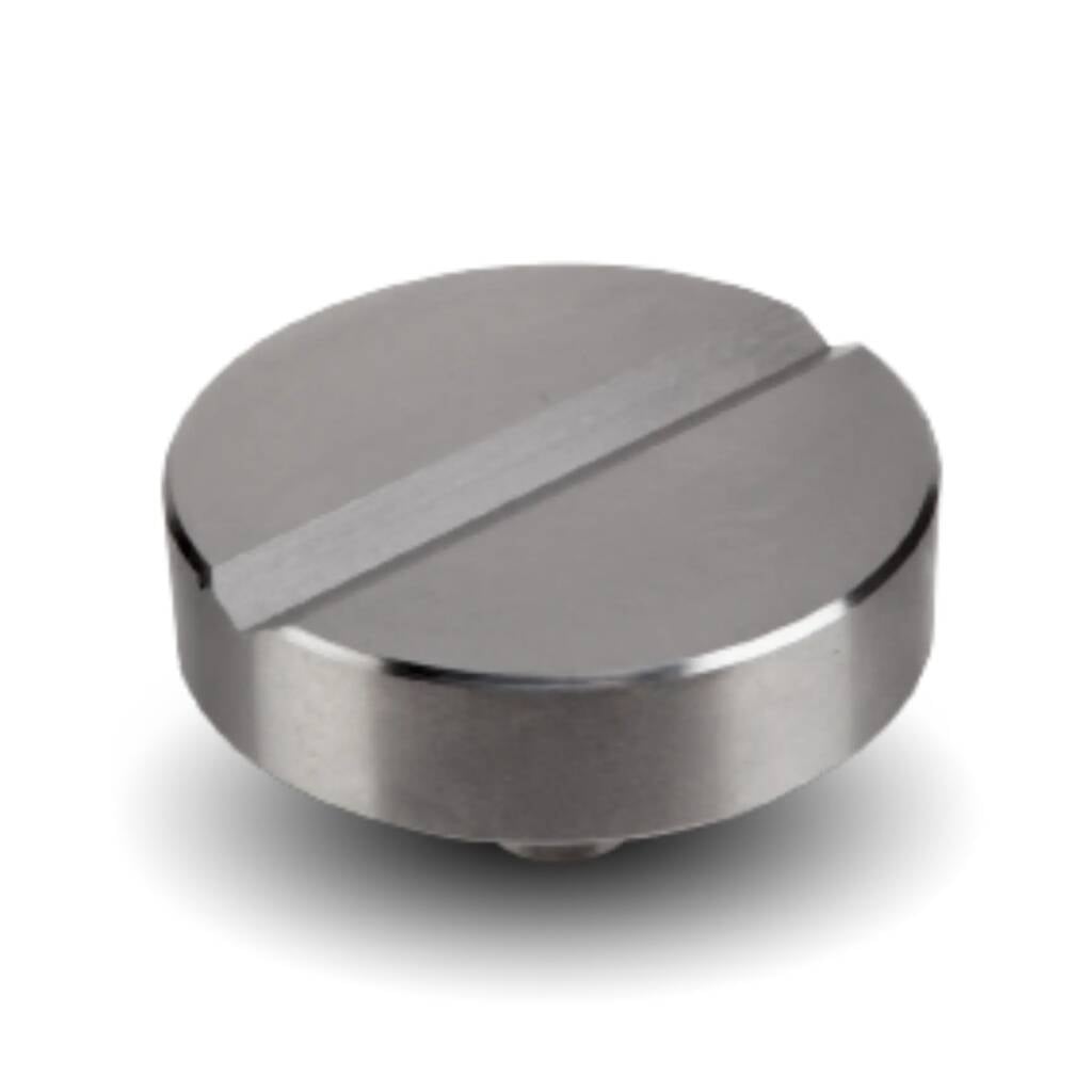 Close-up of a silver, circular knob with a horizontal groove across the top surface.