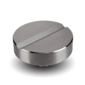 Close-up of a silver, circular knob with a horizontal groove across the top surface.