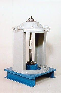 Small laboratory universal testing machine on a blue base, with a gray frame and vertical load assembly for axial material testing