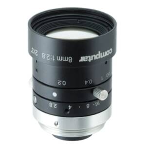 Close-up of a black camera lens with textured rings and white distance markings, showing the focus/zoom controls you would use to adjust an image.