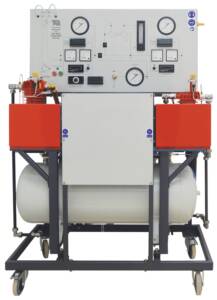 Two-stage compressor test setup on a wheeled frame with gauges, controls, and red side tanks.