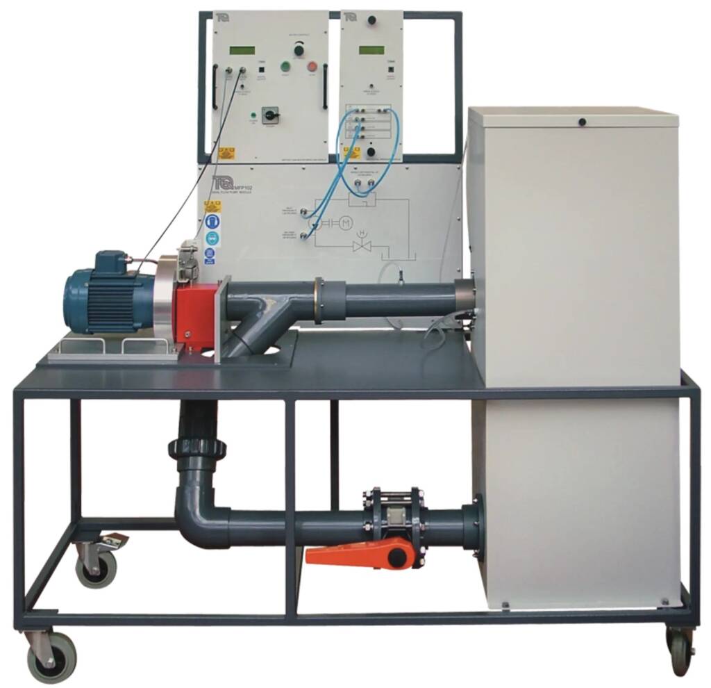 Industrial test rig on a metal frame featuring an electric motor driving a piping system, with a control panel and a grey cabinet nearby. Wheels and supporting structure visible.